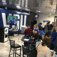 networking and watching the game on tv inside the fieldhouse